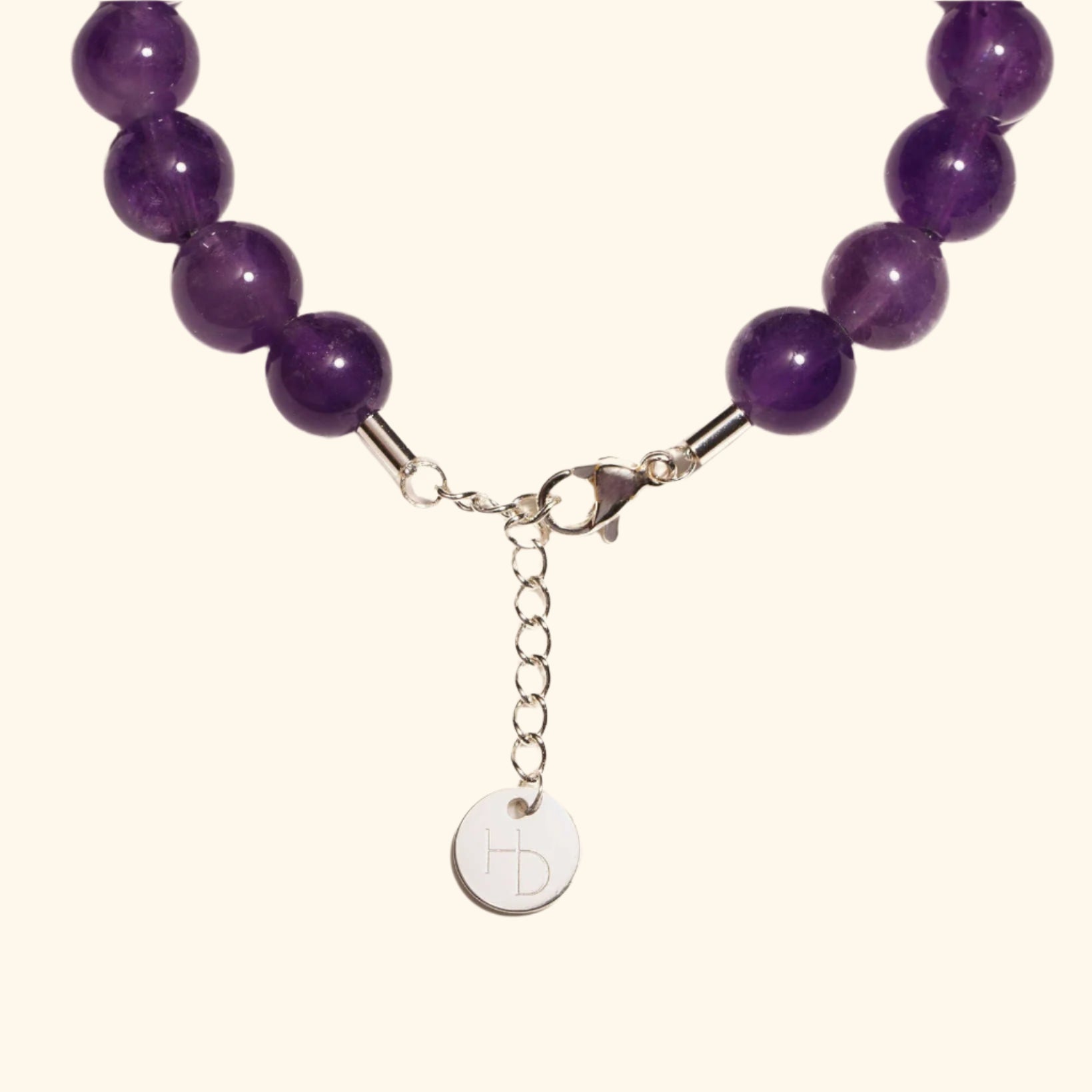 Amethyst silver charm bracelet close up showing the adjustable length extender and clasp