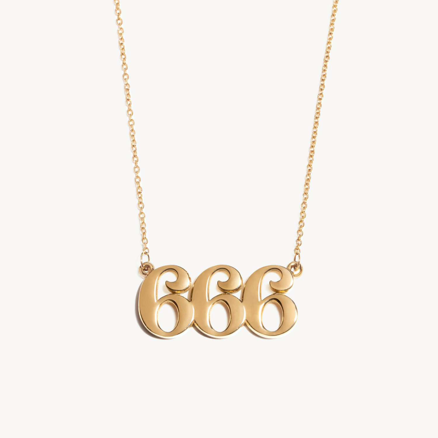 Gold necklace with '666' pendant on a white background and unique high quality design