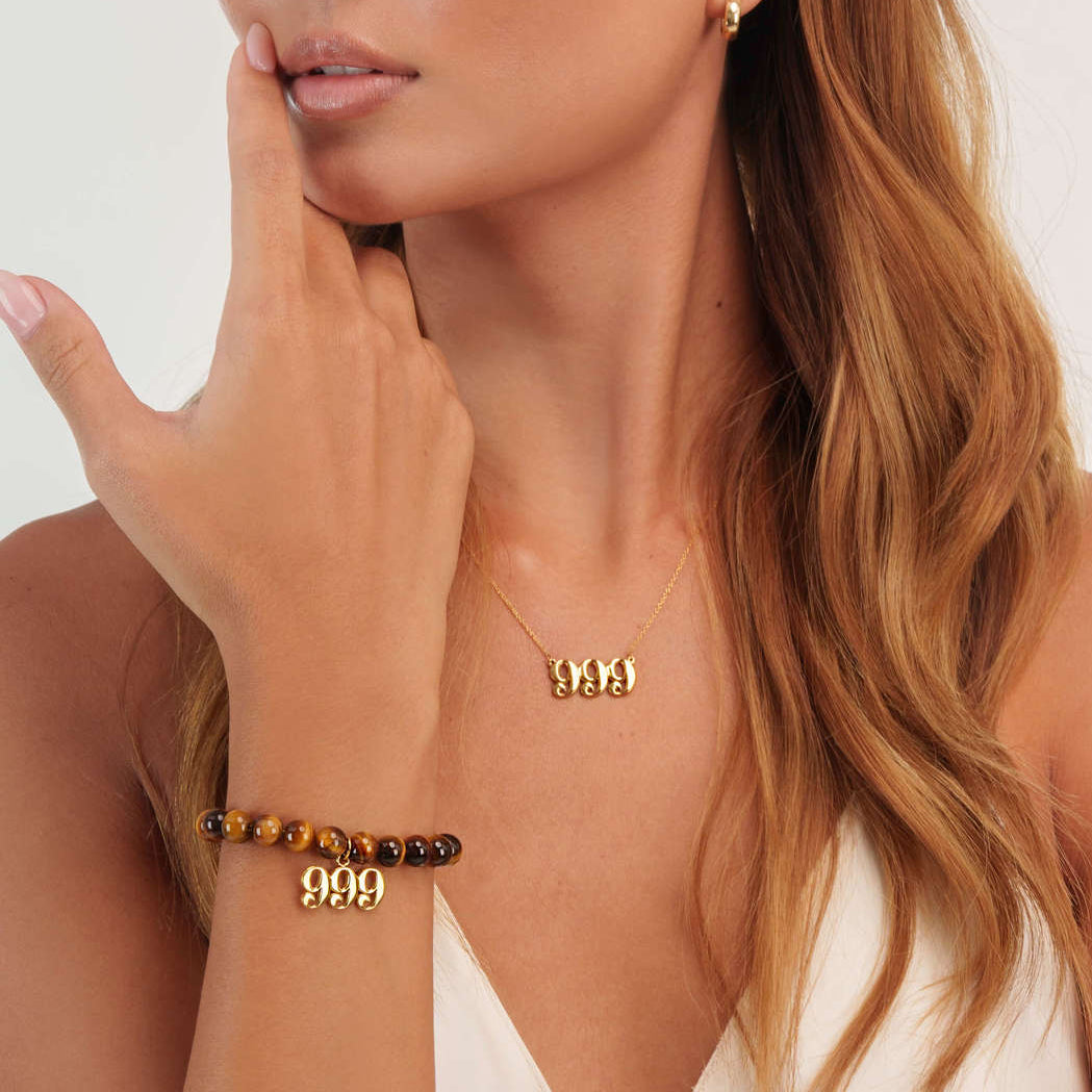 Model wearing a Tigers Eye 999 Gold bracelet with a matching 999 Gold necklace