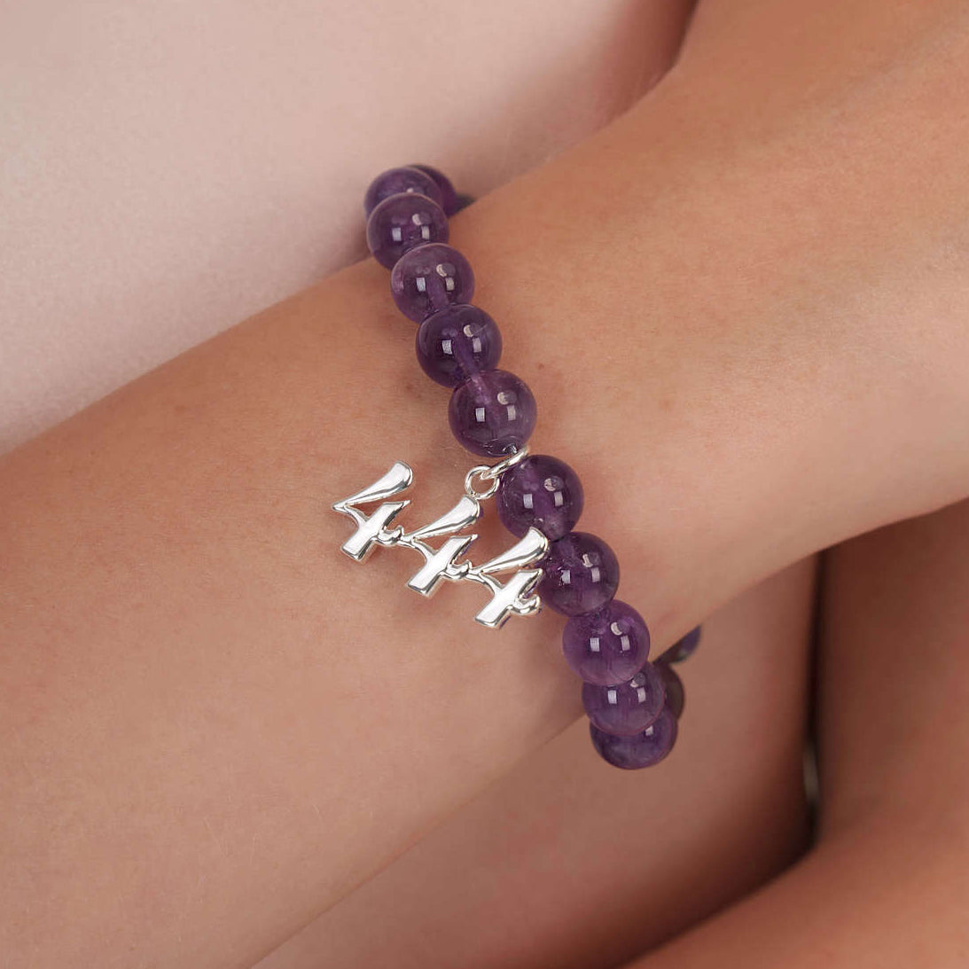 High quality purple amethyst beads with dangling 444 Silver charm on wrist
