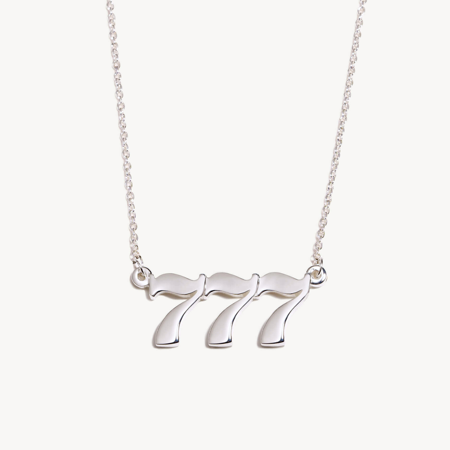 Silver necklace with a unique 777 pendant on a white background