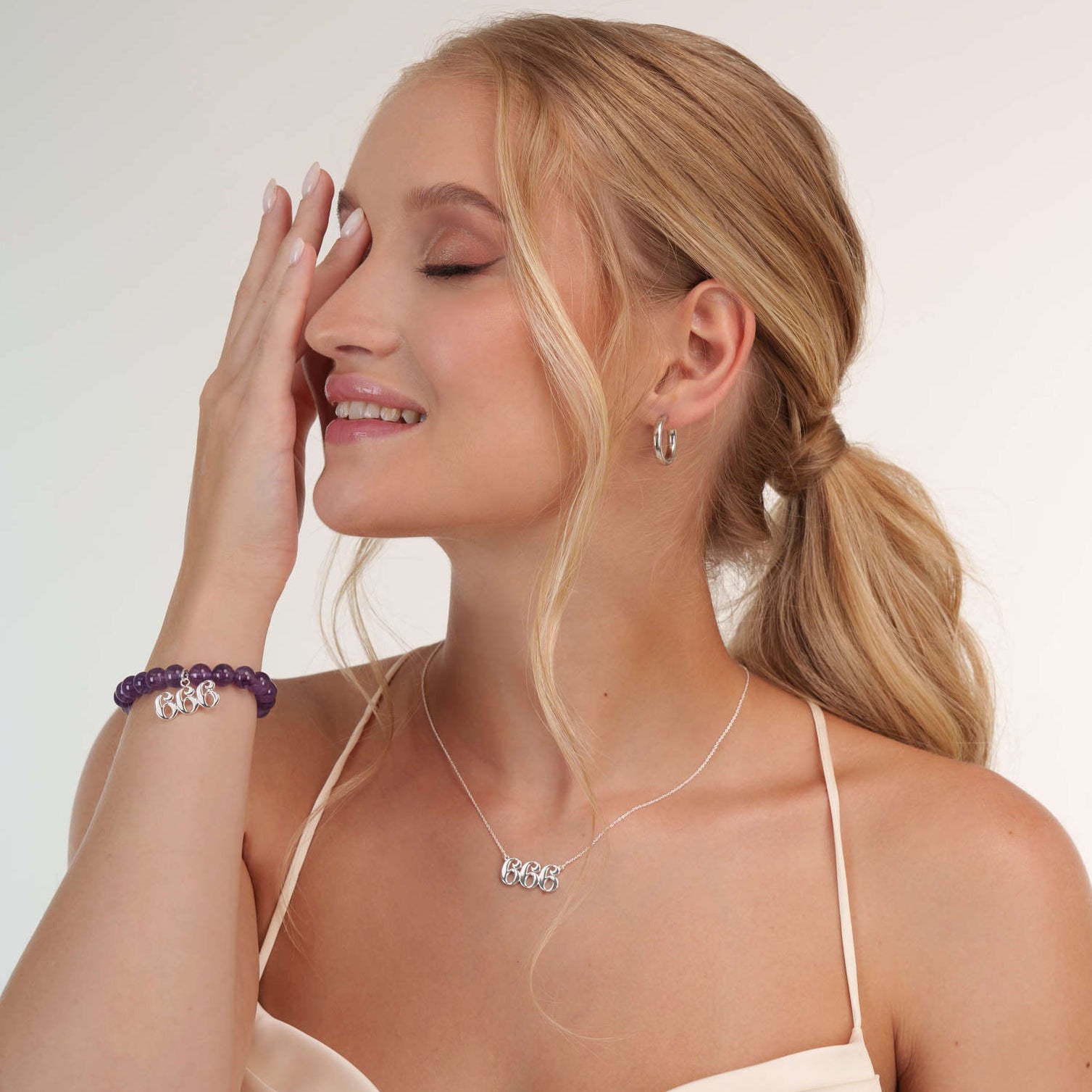 Model wearing an amethyst 666 silver bracelet with a matching 666 silver necklace
