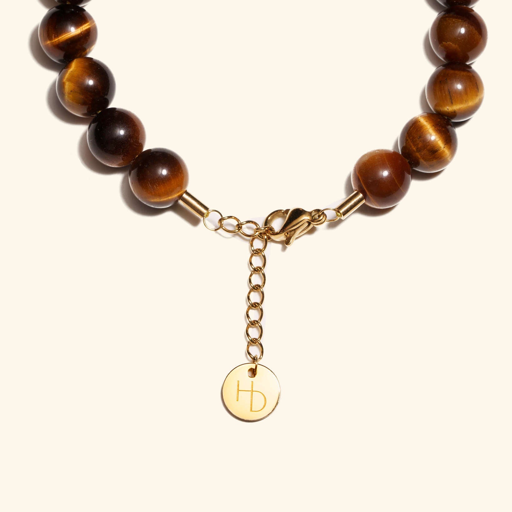 Tigers Eye Gold charm bracelet close up showing the adjustable length extender and clasp