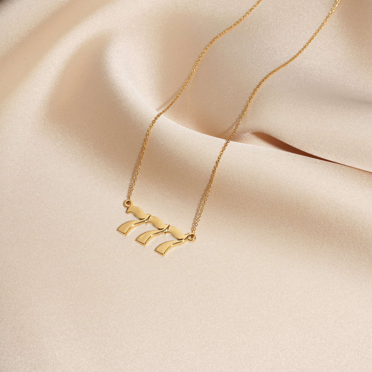 gold 777 necklace with premium design and quality on silk