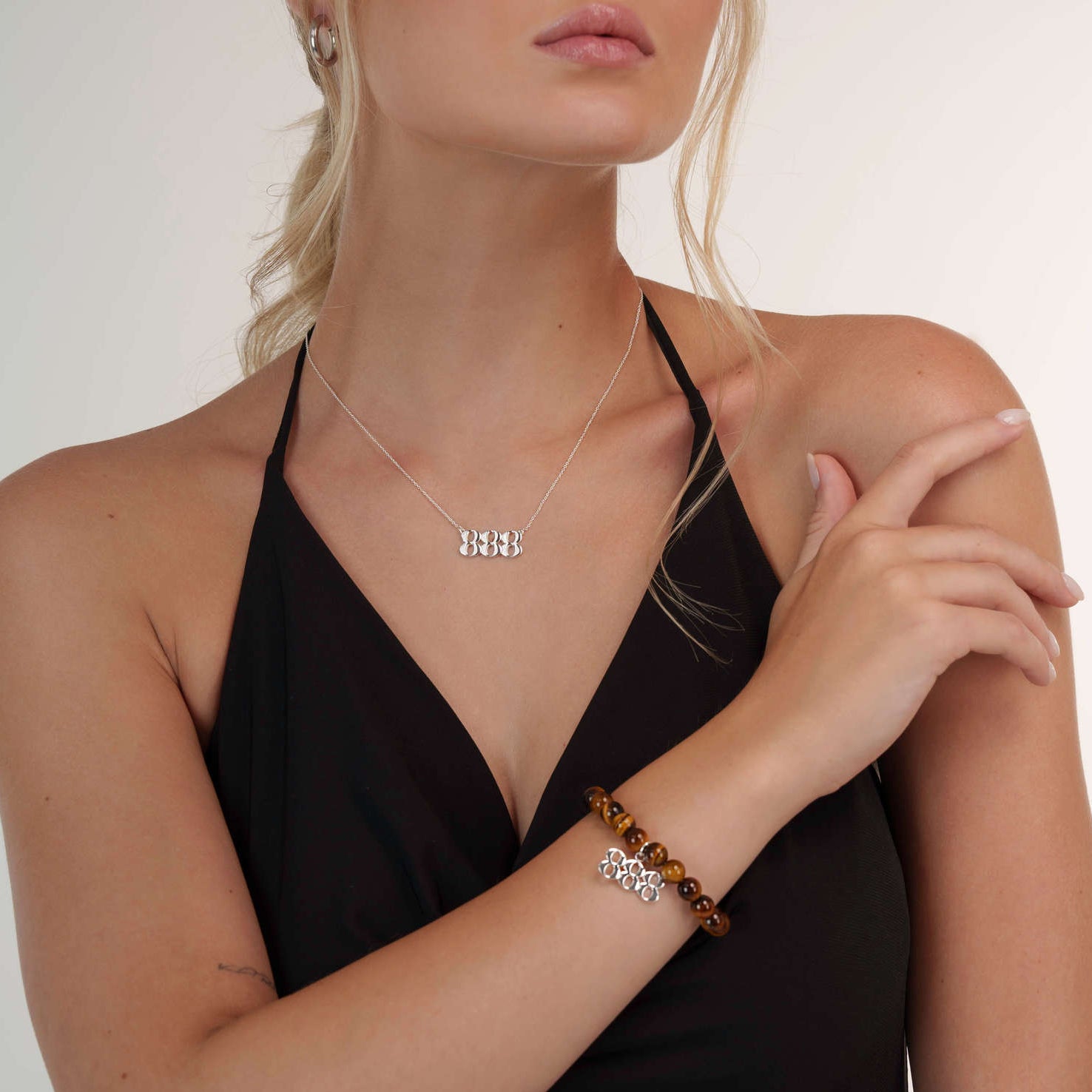 Model wearing an Tigers Eye 888 Silver bracelet with a matching 888 Silver necklace
