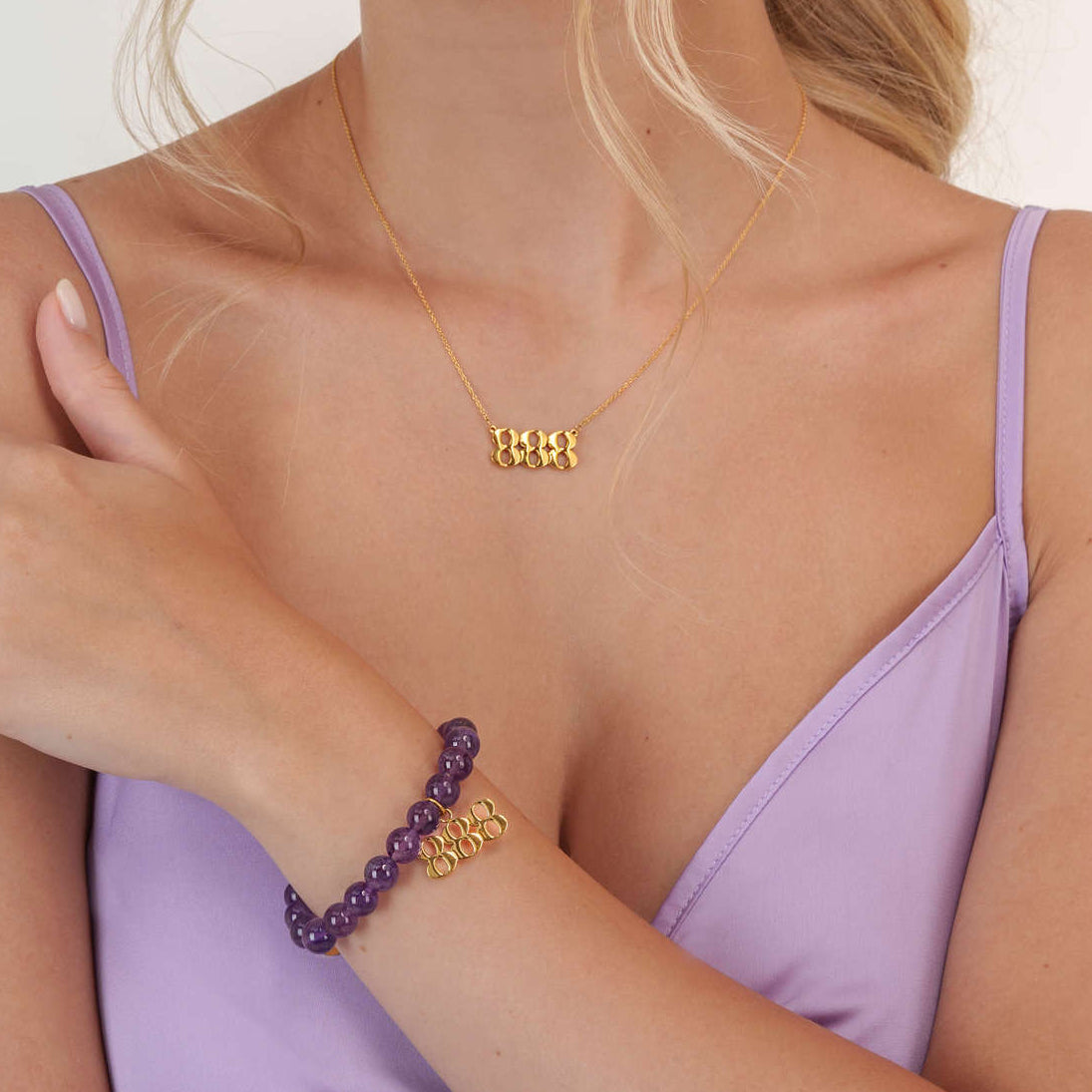 Model wearing a 888 gold bracelet with a matching 888 gold necklace