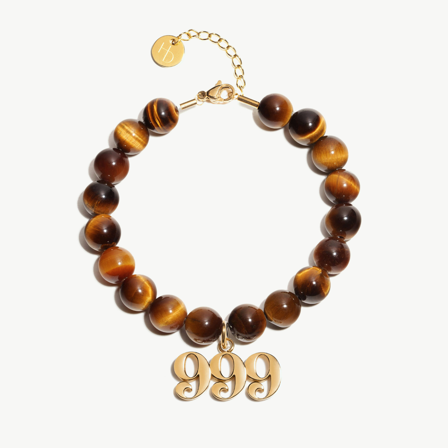 999 Tigers Eye beaded bracelet with adjustable clasp closure. 999 Gold Charm

