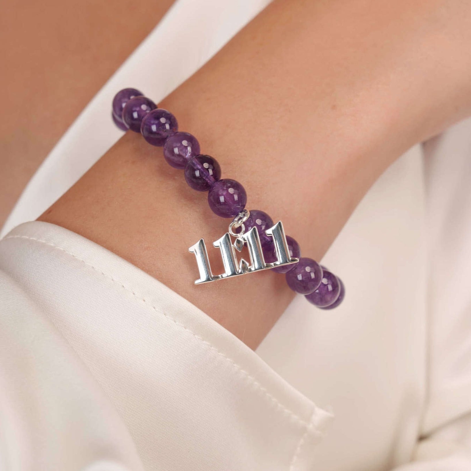 High quality purple amethyst beads with dangling 11:11 Silver charm on wrist
