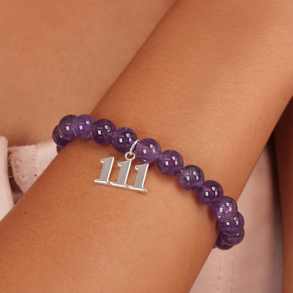 High quality purple amethyst beads with dangling 1111 Silver charm on wrist

