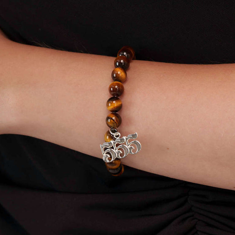 High quality Tigers Eye beads with dangling 555 Silver charm on wrist
