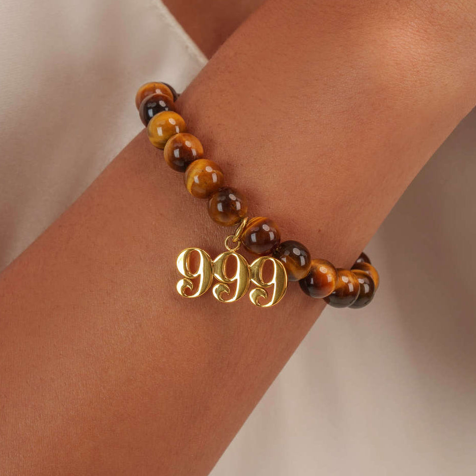 High quality Tigers Eye beads with dangling 999 Gold charm on wrist
