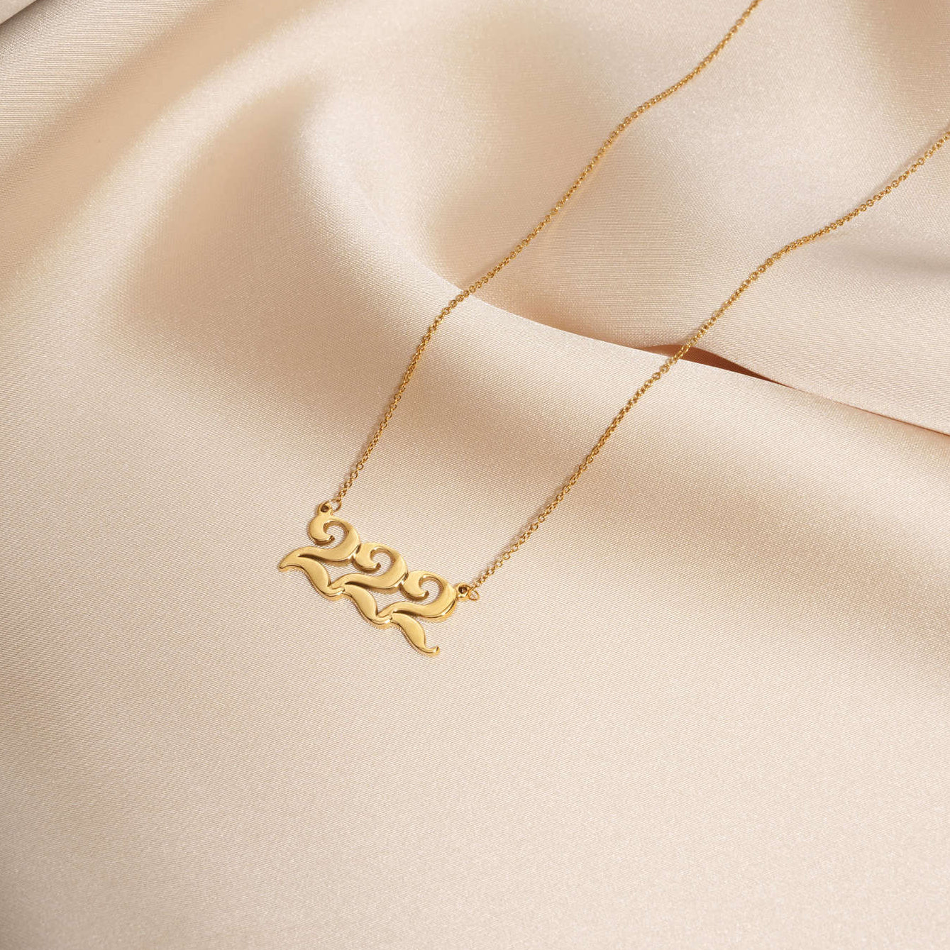 222 gold necklace with unique design on silk